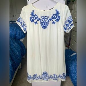 White mini dress with blue floral embroidery